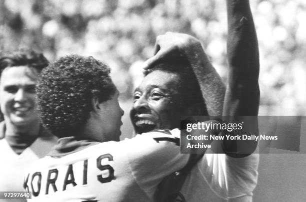 New York Cosmos' players hug Pele after he scores a goal in the 2nd period.