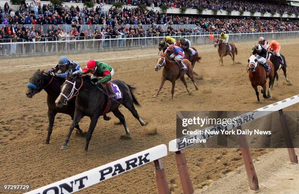 Silver Train , with jockey Edgar Prado up, and Taste of Paradise, ridden by jockey Garrett Gomez , are in the lead as racehorses round the track in...
