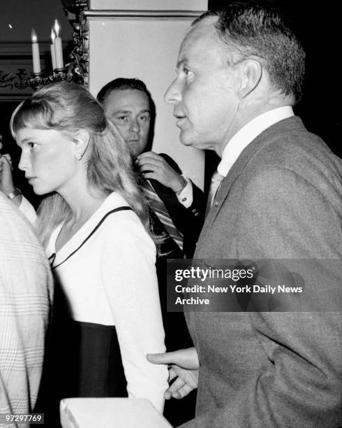 Frank Sinatra with Mia Farrow exit up aisle of Shubert Theater during intermission. He left in a huff because he was informed the press was present...