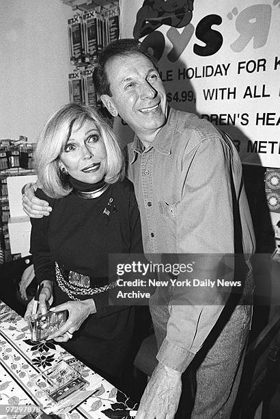 Freddy Cannon and Nancy Sinatra autograph "A Miracle Holiday for Kids" albums for the benefit of the Children Miracle Network at Toys "R" Us.