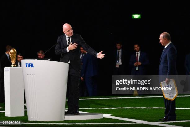 Russian President Vladimir Putin and FIFA president Gianni Infantino attend the 68th FIFA Congress at the Expocentre in Moscow on June 13, 2018.