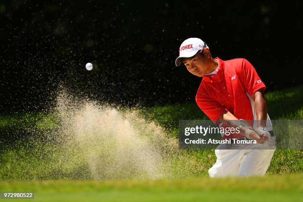 Ryo Hisatsune of Japan hits from a bunker on the 16th hole during the second round of the Toyota Junior Golf World Cup at Chukyo Golf Club on June...