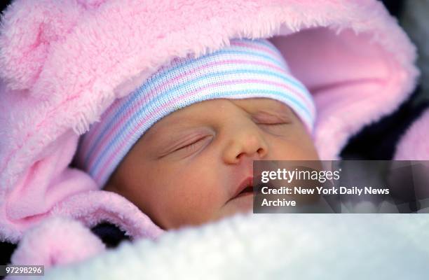 Tiny Francesca St. James, one of the newborn twin babies of 57-year-old Aleta St. James, is carried out from Mount Sinai Medical Center shortly after...