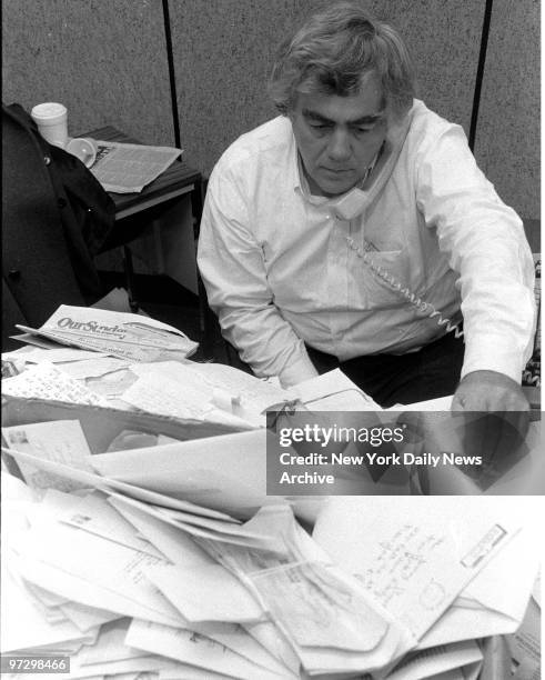 Jimmy Breslin in his office at the Daily News reading his mail