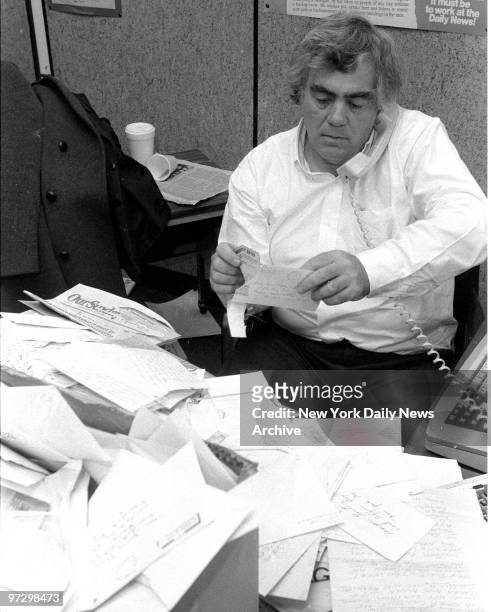 Jimmy Breslin in his office at the Daily News reading his mail