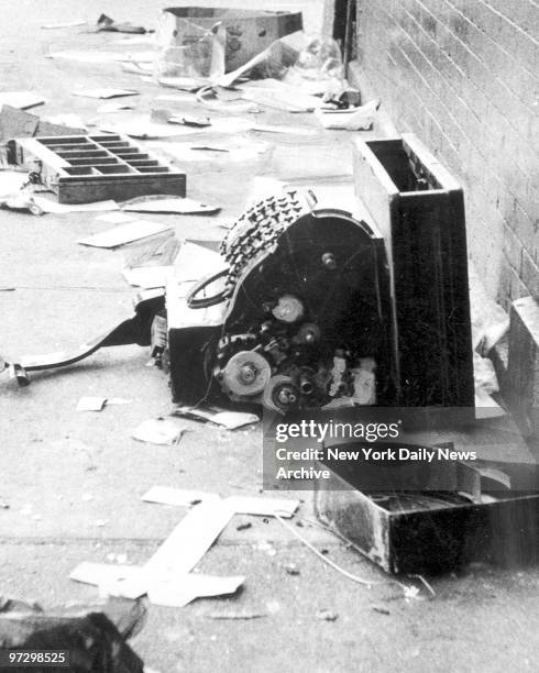 Smashed cash register lies amid debris on Harlem street after night of looting during 1977 blackout power failure.