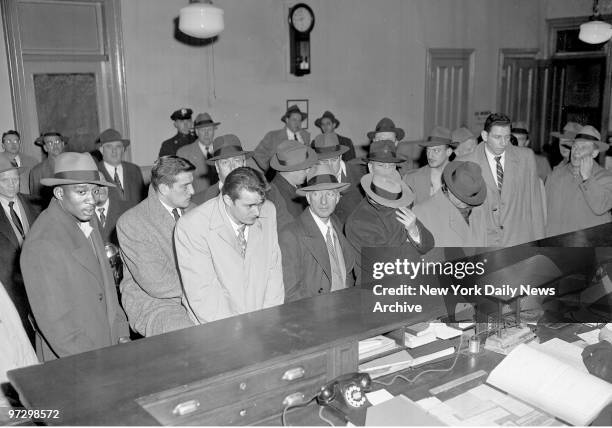 Basketball Fix...Cage stars, accused briber and material witness are booked at Elizabeth Street Station. Detective stand in the middle., Ed Warner,...