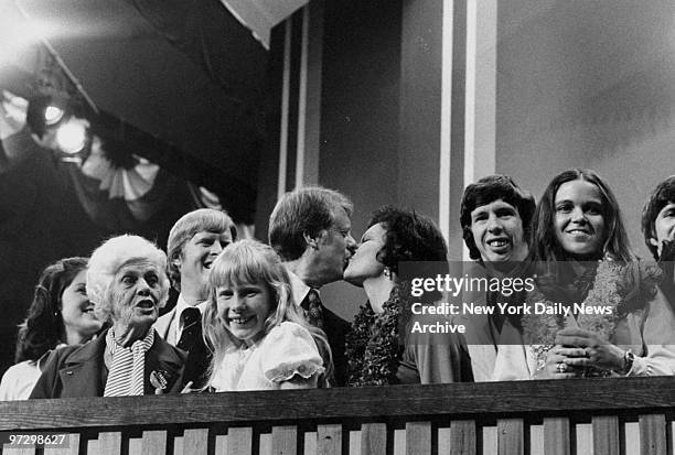 Jimmy Carter, amidst his family, kisses his wife Rosalynn at the National Democratic National Convention at Madison Square Garden.