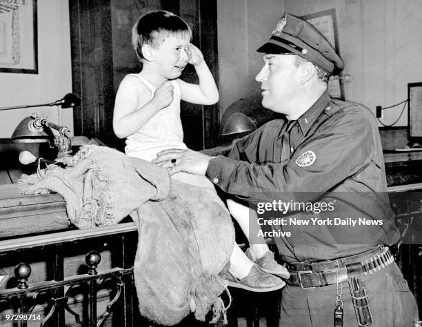 Jimmy Doyle cries as policeman Tom Pritchard listens to story of why the boy ran away from home. Jimmy Doyle moaned "Mamma has a dog she likes better...