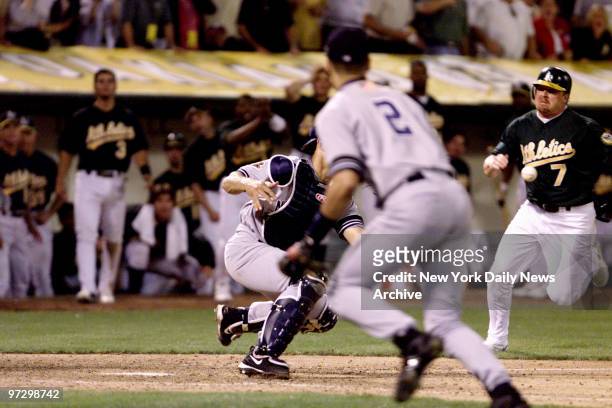 New York Yankees' Jorge Posada holds on to ball after sweep tag on Oakland Athletics' Jeremy Giambi during Game 3 of American League Division Series....