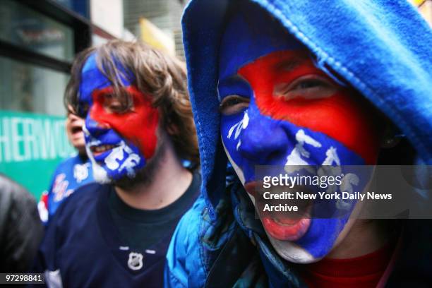 Cecile Monteyne and her brother Jules painted their faces to join other New York Rangers fans in Times Square for a rally in support of their team,...