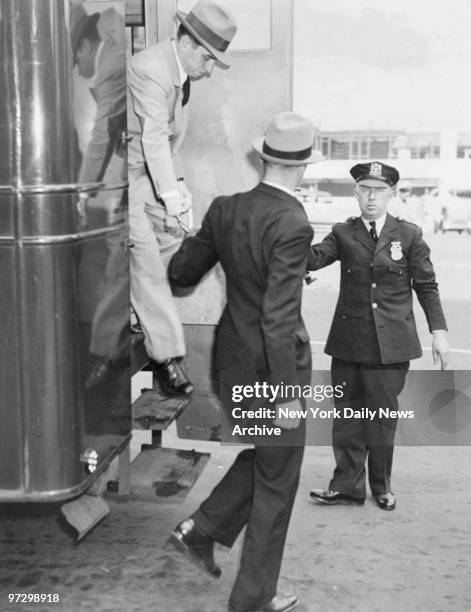 Charles "Lucky" Luciano leaves paddy wagon to attend his vice trial at the New York Supreme Court.