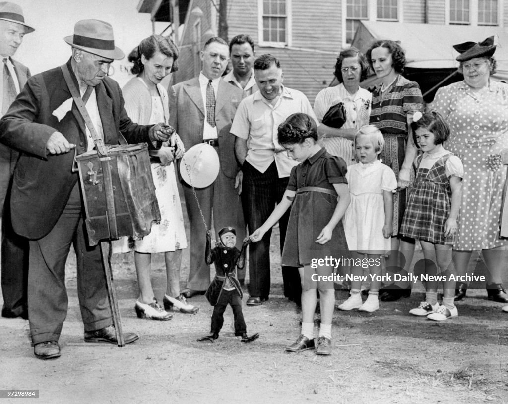 Jimmy, the penny-snatching monkey, attracts a large crowd at