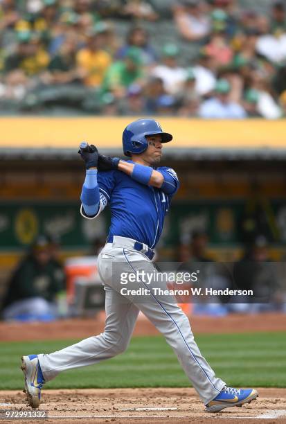 Ryan Goins of the Kansas City Royals hits a double against the Oakland Athletics in the top of the second inning at the Oakland Alameda Coliseum on...