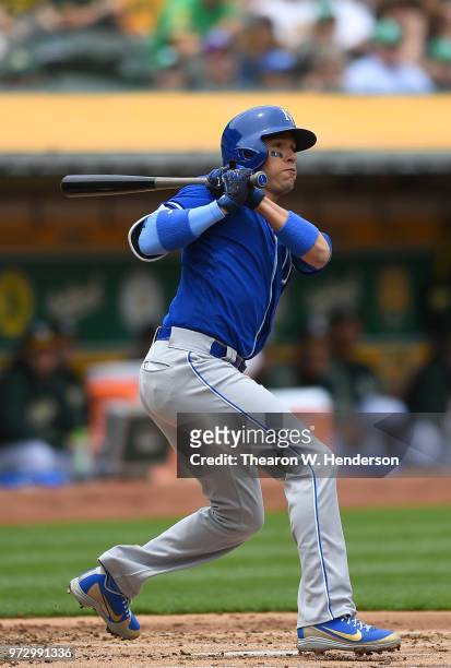 Ryan Goins of the Kansas City Royals hits a double against the Oakland Athletics in the top of the second inning at the Oakland Alameda Coliseum on...