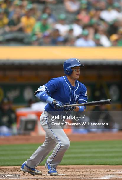 Ryan Goins of the Kansas City Royals hits a double against the Oakland Athletics in the top of the second inning at the Oakland Alameda Coliseum on...