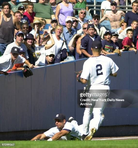 New York Yankees' Juan Rivera makes a diving catch in the seventh inning as shortstop Derek Jeter looks on. The rookie left fielder's play preserved...
