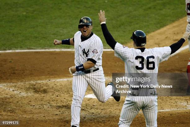 New York Yankees' Karim Garcia and and Nick Johnson celebrate their runs in the fourth inning of Game 6 of the American League Championship Series...