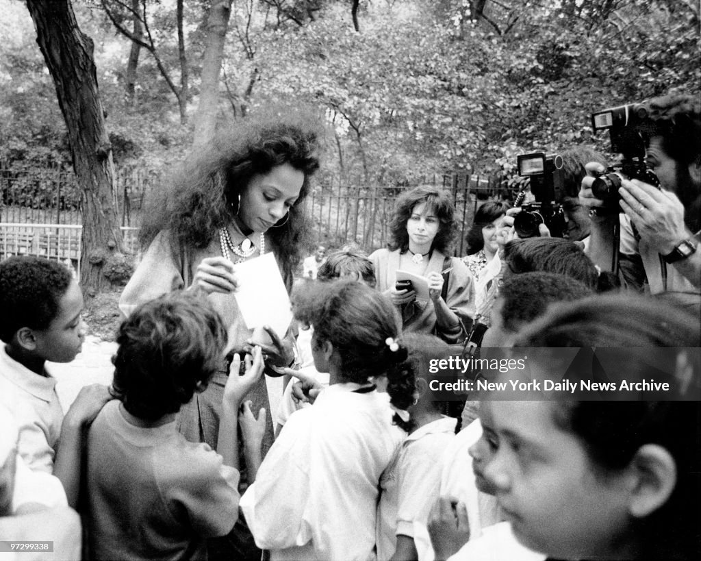 Singer Diana Ross signs autographs for fans during groundbre