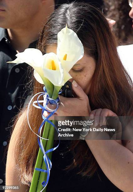 Melissa Vicens, the widow of fallen NYPD Officer Eric Concepcion, kisses his badge after funeral services at St. Brendan's Church on E. 206th St. In...