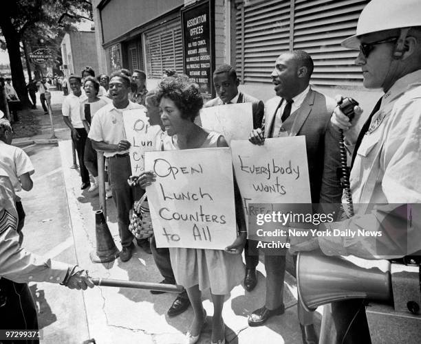 Singer Dick Gregory leads demonstrators to jail while police control the scene in Birmingham, Ala.