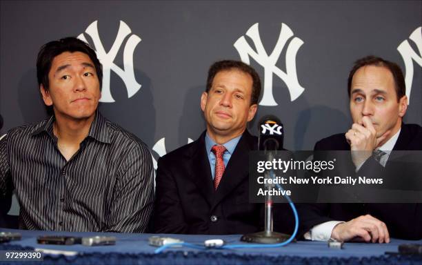 New York Yankees' left fielder Hideki Matsui sits with his agent, Arn Tellem, and Yankees' General Manager Brian Cashman , during a news conference...