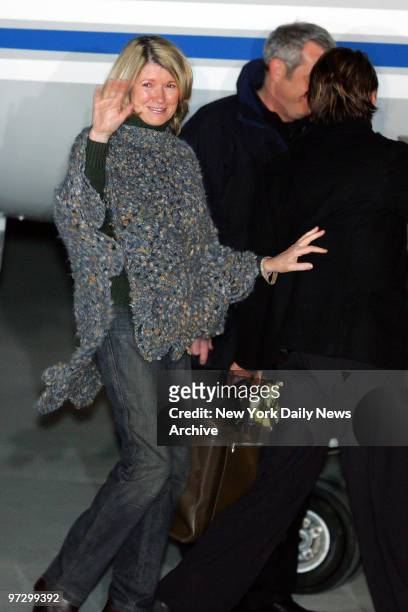 Martha Stewart waves cheerfully as she boards a plane at the Greenbriar Valley Airport in Lewisburg, W. Va. After her release from Alderson Federal...