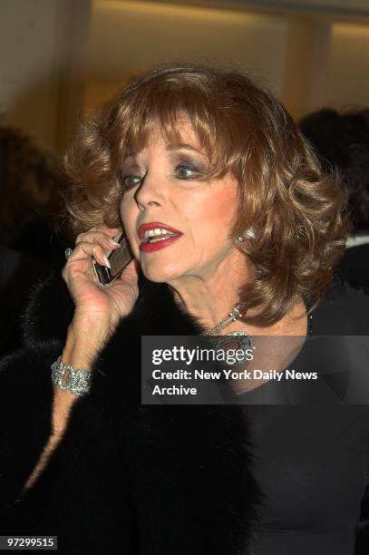 Joan Collins has a word on her cell phone as she attends the grand opening of the Dennis Basso flagship store on Madison Ave.