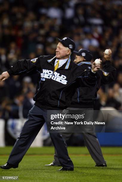 New York Yankees' legends Whitey Ford and Yogi Berra throw out the ceremonial first pitches during Game 1 of the World Series between the Yankees and...