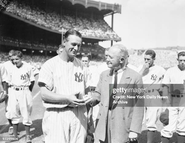 New York Yankees' Lou Gehrig receives award for most valuable player in American League from George M. Cohan.