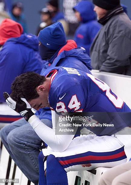 New York Giants' Joe Jurevicius holds his head on the bench as final minutes tick away in game against the Minnesota Vikings. The Vikings won, 34...