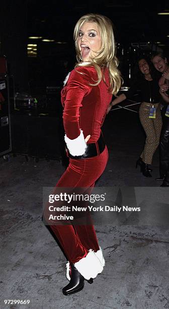 Singer Jessica Simpson strikes a pose in her Santa-like jumpsuit as she arrives at Madison Square Garden for radio station Z100's "Jingle Ball 2000"...