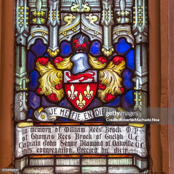 Close-up of stained glass at the Saint James Cathedral. The sign reads: 'Je me fie en Dieu' and it is in memory of William Rees Brock.