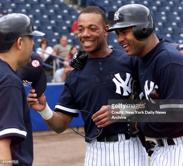 New York Yankees' Luis Sojo, Gerald Williams and Ruben Rivera share a laugh at spring training camp at Legends Field.