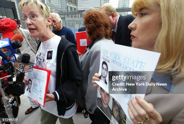 Joan Molinaro and Sally Regenhard, mother of 9/11 victims Carl Molinaro and Firefighter Christian Regenhard, hold blowups of the driver's license...