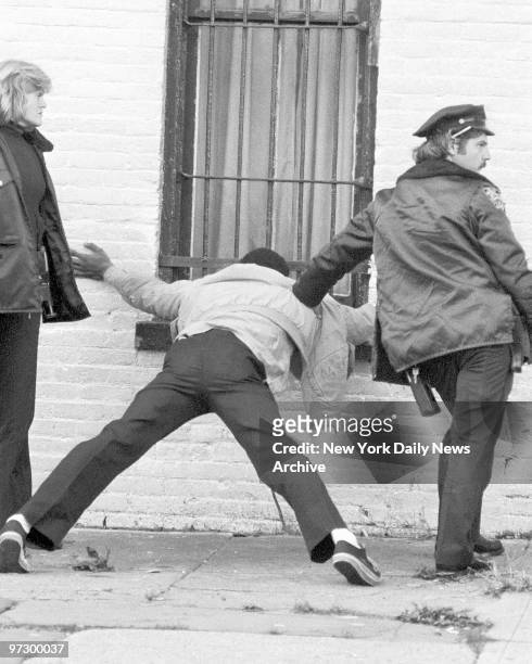 This patron assumes the position as policeman is about to check for a weapon at a social club at 220 Howard Ave. In Bedford-Stuyvesant, Brooklyn....