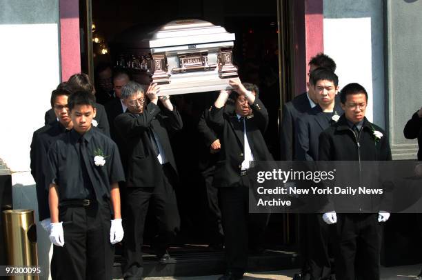 Friends and family members bear the coffin of April Lao from the Chun Fook Funeral Home in Flushing, Queens, after services for the teen. The...