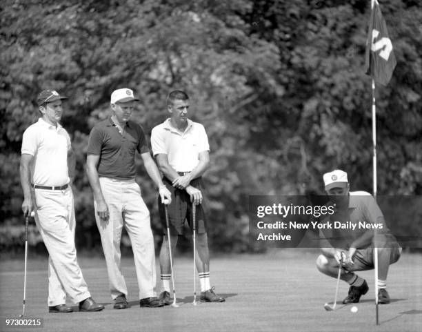 Daily News Ike Golf Tournament. Bill Kuntz of Bonnie Briar lines up putt on second green at Tamarack as Jim and Pete Bostwick of Meadow Brook and...
