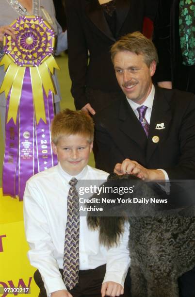 Ch. Torums Scarf Michael, a 6-year-old Kerry blue terrier, is joined by handler Bill McFadden and son Connor after taking the award for Best in Show...
