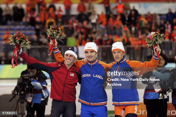 Chad Hedrick of the U.S. Is joined by Bob de Jong and Carl Verheijen of the Netherlands on the podium after competing in the Men's 10,000-meter Speed...
