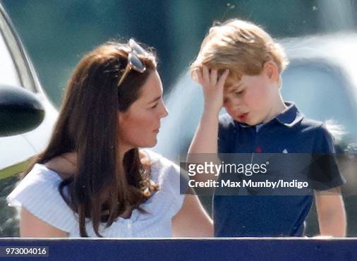 Catherine, Duchess of Cambridge comforts Prince George of Cambridge as they attend the Maserati Royal Charity Polo Trophy at the Beaufort Polo Club...