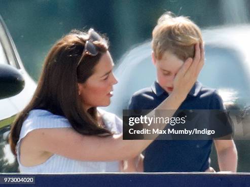 Catherine, Duchess of Cambridge comforts Prince George of Cambridge as they attend the Maserati Royal Charity Polo Trophy at the Beaufort Polo Club...