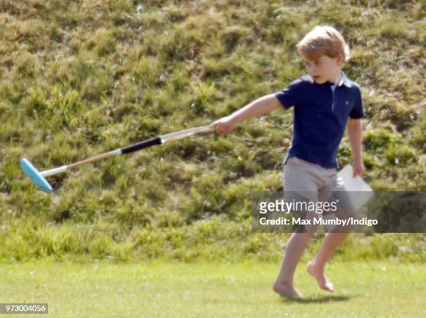 Prince George of Cambridge swings a polo mallet as he attends the Maserati Royal Charity Polo Trophy at the Beaufort Polo Club on June 10, 2018 in...