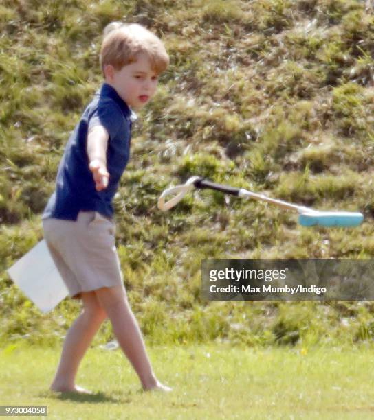 Prince George of Cambridge swings a polo mallet as he attends the Maserati Royal Charity Polo Trophy at the Beaufort Polo Club on June 10, 2018 in...