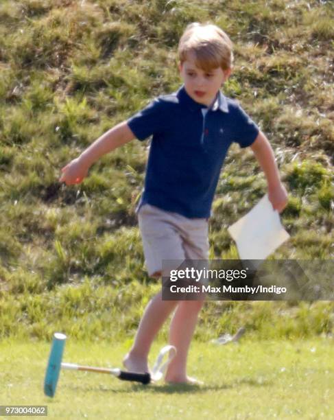 Prince George of Cambridge swings a polo mallet as he attends the Maserati Royal Charity Polo Trophy at the Beaufort Polo Club on June 10, 2018 in...