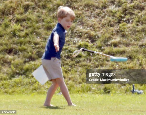 Prince George of Cambridge swings a polo mallet as he attends the Maserati Royal Charity Polo Trophy at the Beaufort Polo Club on June 10, 2018 in...