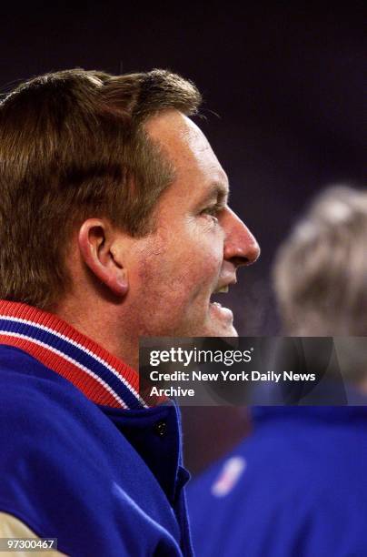 New York Giants' coach Jim Fassel smiles approvingly as he follows the action against the Philadelphia Eagles in the National Football Conference...