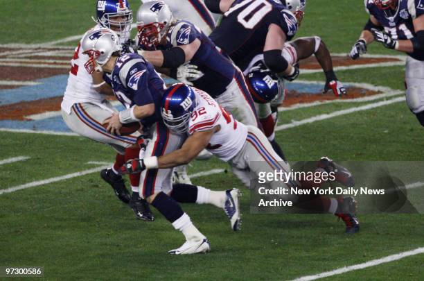 New York Giants' defensive end Michael Strahan sacks New England Patriots' quarterback Tom Brady in the third quarter of Super Bowl XLII at the...