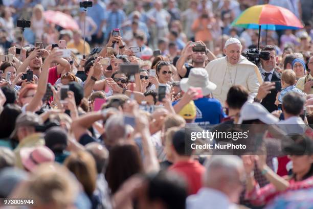 Pope Francis waves to faithful as he arrives to attend his weekly general audience, in St. Peter's Square, at the Vatican, Wednesday, June 13, 2018.