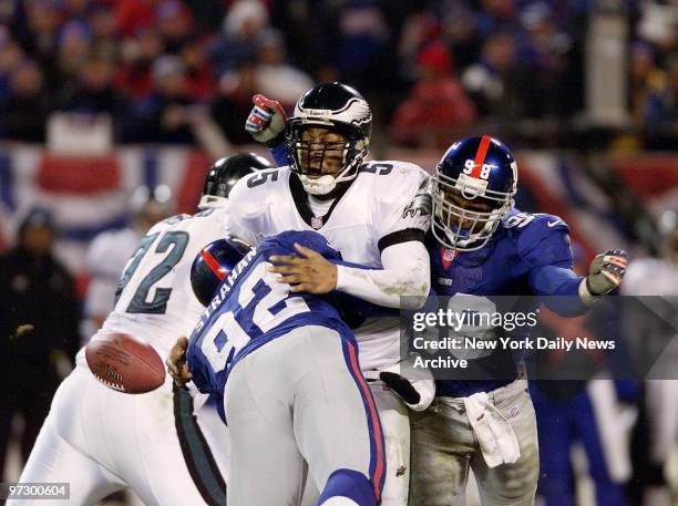 New York Giants' defensive end Michael Strahan sacks Philadelphia Eagles' quarterback Donovan McNabb causing him to fumble in National Football...
